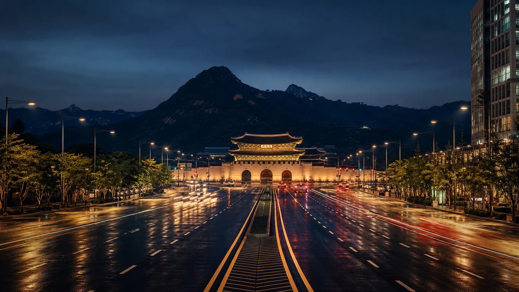 Gwanghwamun at night with the city lit behind it